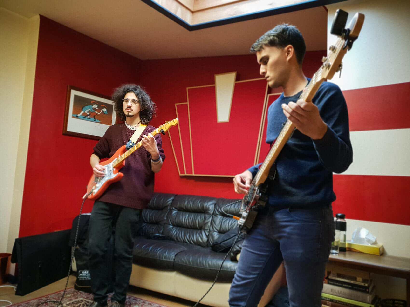 Two men playing guitars